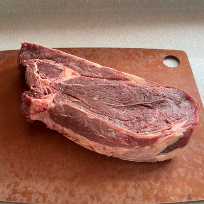 grass fed Arm roast on a wooden cutting board